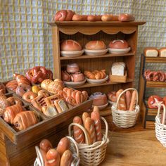 there are many breads and pastries on display in this room, including baguettes