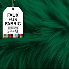 a tag with the words faux fur fabric by the yard is shown on a green background