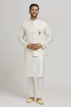 Cream bundi with thread embroidered peacock patterns and sequin work embellishments. Comes with inner kurta and pant. - Aza Fashions Diwali Nehru Jacket With Straight Kurta And Intricate Embroidery, Elegant Chanderi Nehru Jacket For Diwali, Transitional Chanderi Nehru Jacket For Reception, Chanderi Nehru Jacket With Cutdana For Reception, Chanderi Nehru Jacket With Chikankari Embroidery For Reception, Chanderi Nehru Jacket For Reception And Festivals, Chikankari Embroidery Chanderi Nehru Jacket For Reception, Wedding Nehru Jacket In Chanderi With Cutdana, Festive Designer Nehru Jacket With Chikankari Embroidery