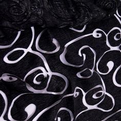 the black and white fabric has swirls on it