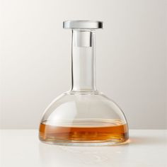 a glass flask filled with liquid on top of a table