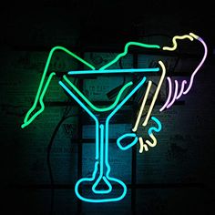 a neon sign that is lit up in the dark with a martini glass on it