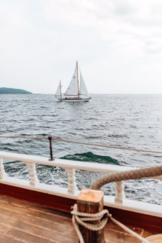 a sailboat in the ocean on a cloudy day