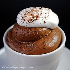 a cup filled with chocolate pudding topped with whipped cream