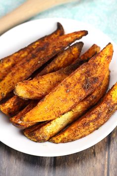 oven roasted cajun sweet potato wedges on a white plate with text overlay