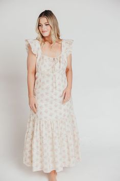 Whether you're frolicking through a field of wildflowers, touring a sunny Greek isle, or attending a springtime baby shower, the Emery Midi Dress will ensure you do it looking like a goddess. We designed this premium dress with an ultra-flattering neckline and a figure-skimming silhouette, paired with a flounced skirt and sweet ruffle details. The Emery is guaranteed to be one of your most feminine (and most favorite!) pieces. FIT: Runs very fitted. This dress is designed with a fit-and-flare profile, and is fitted through the waist and hips. Fabric does not stretch, so we recommend sizing up for more room in the hips MATERIAL: Self: 75% Rayon, 25% Nylon; Lining: 100% Cotton. GARMENT DETAILS: Lightweight summer dress in a long midi length and pastel floral print chiffon. Features a square Spring Bohemian Maxi Dress With Ditsy Floral Print, Bohemian Ditsy Floral Print Maxi Dress For Spring, Bohemian Maxi Dress With Ditsy Floral Print For Spring, Cotton Sundress For Garden Party In Spring, Spring Garden Party Cotton Sundress, Spring Casual Prairie Dress For Garden Party, Bohemian Ditsy Floral Print Dress For Spring, Casual Spring Prairie Dress For Garden Party, Casual Floral Dress For Picnic In Spring