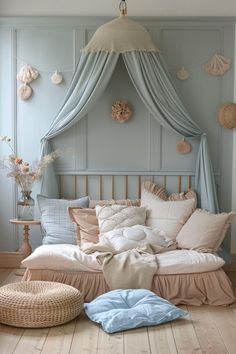 a bed sitting on top of a hard wood floor next to a basket filled with pillows