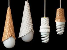 three light bulbs with cones hanging from them