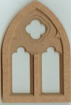 a paper cutout of an arch with two windows