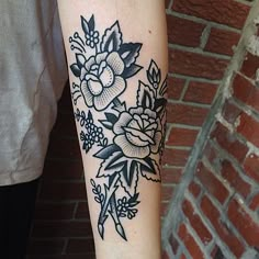 a woman's arm with a flower tattoo on it