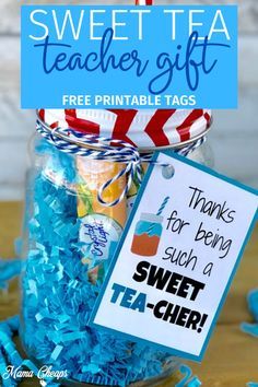 a jar filled with blue shredded paper and a teacher's gift tag on top