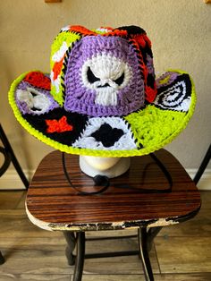 a crocheted hat sitting on top of a wooden table