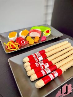 two trays filled with different types of food on top of a table next to each other