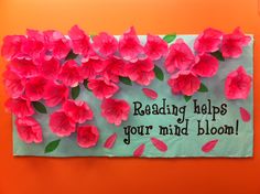 a bulletin board with flowers on it that says reading helps your mind bloom