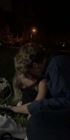 a man and woman kissing in the dark