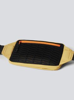 a black and yellow belt bag with an orange zipper