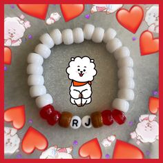 a white bear bracelet with red hearts around it and the word rj spelled in small letters