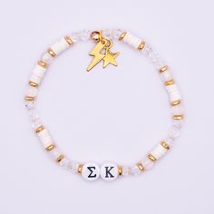 "Our Sigma Kappa sorority bracelet is a beautiful and meaningful piece of jewelry to show pride in your sisterhood. It's the perfect gift for your big, little, sorority sister, or daughter in greek life! Handmade with love and created with high-quality materials (see specifications below) this bracelet will stand the test of time, and be a bracelet you can take with you for the rest of your life. Get one for yourself, or get multiple to match with your big, little, or entire family! Available in 5 color-ways. Looking to order in-bulk for your entire sorority or a larger group of girls? We have bulk-discounts, send us a message! Available in Pink, Purple. White, Blue, & Orange. Small  - 6.5\"  Average - 7\" Large - 7.5\" Specifications: -Hand-crafted crystal, gemstone and gold beaded bracel White Beaded Friendship Bracelets With Charms, Adjustable White Bracelet Souvenir, Kappa Sorority, Letters Sorority, Sigma Kappa Sorority, Sorority Jewelry, Sorority Letters, Hardware Jewelry, Sorority Sisters