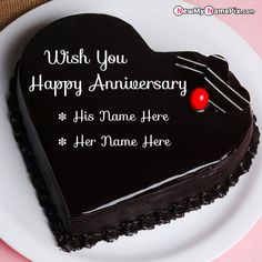 a heart shaped cake on a plate with the words, wish you happy anniversary his name here her name here