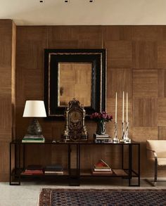 a living room with wood paneling and a mirror on the wall next to a couch