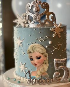 a frozen princess themed birthday cake with snowflakes