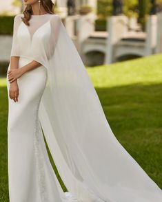 a woman in a white wedding gown and veil