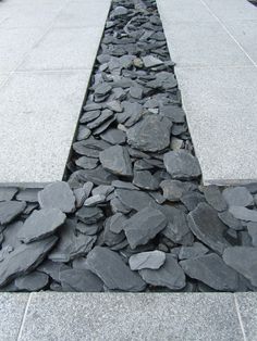 a long line of rocks on the sidewalk