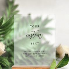 a card with the text your custom text on it next to some flowers and greenery