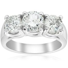 three stone diamond ring in white gold with diamonds on the sides and four stones at the top