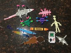 several beaded keychains are arranged on a counter top, including an airplane