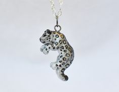 IMPORTANT: Due to a surge in holiday orders I currently have a 2-3 week waiting period for all orders before I can ship them. Please take this into account before ordering as unfortunately I am not able to ensure delivery of an item before 2-3 weeks. I am very sorry for any trouble. ----------------------------- A perfect gift for yourself or the snow leopard lover in your life! This dashing one sided snow leopard was cast in resin, hand painted with acrylic paints and metallic rub, then finishe Snow Leopard Jewelry, Fox Cake Toppers, Leopard Jewelry, Leopard Accessories, Leopard Necklace, Shadow And Bone, The Leopard, Black Wolf, Colored Gems