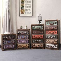 five drawers are stacked on top of each other in front of a window with a birdcage