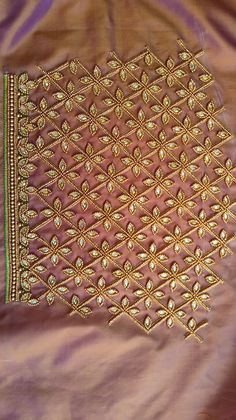 an embroidered cloth with gold thread work on it