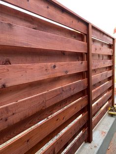 a wooden fence that is next to a building