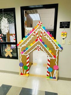 a gingerbread house made out of cardboard on the floor