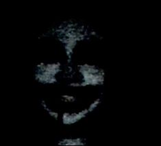 the face of a person with black and white paint on it's face is lit up in the dark