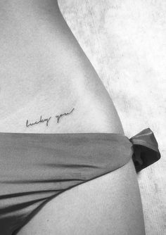 a woman's stomach with the words baby you tattooed on it