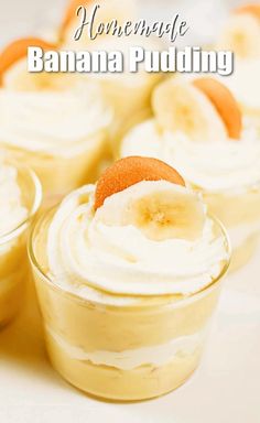 banana pudding in small glass dishes with whipped cream and orange peel on top, sitting on a white surface