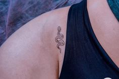 a woman with a snake tattoo on her shoulder