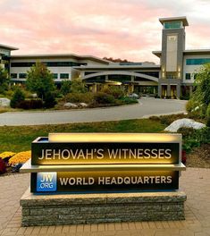 there is a large sign in front of a building that says jehovah's witnessess world headquarters