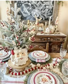 a christmas table setting with santa clause on it