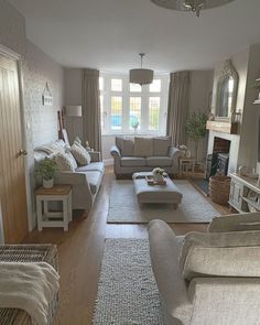 a living room filled with furniture and a fire place