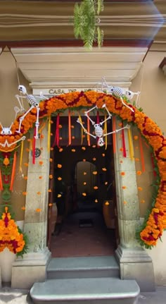 an entrance decorated with orange flowers and decorations