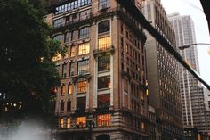 a tall building with lots of windows next to a street