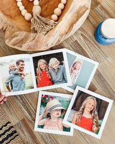 four polaroid photos sitting on top of a wooden table next to a bowl and candle