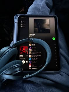 a tablet with headphones sitting on top of it