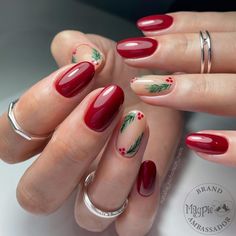 This elegant oval-shaped nail design combines deep red polish with delicate holly berry and pine branch accents on a neutral base. The glossy finish of the simple red nails contrasts beautifully with the green botanical details, making it a minimalist yet festive choice for the holidays. This look is perfect for someone who wants a classic yet seasonal design. Red Oval Nails, Trendy Christmas Nails, Christmas Nails Designs, Short Oval Nails, Berry Nails, Oval Shaped Nails, Red Christmas Nails, Red Acrylic Nails, Long Acrylic Nail Designs