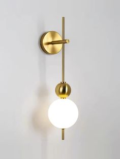 a wall light that is on the side of a wall with two balls attached to it