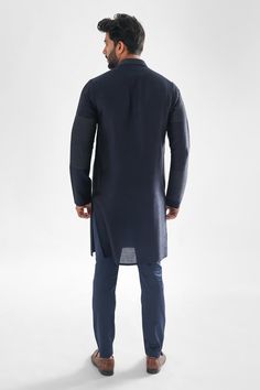 Navy blue bam silk kurta with mandarin collar, pintucked panels and contrast running stitch thread embroidery. Paired with malai cotton pant.
Components: 2
Pattern: Embroidered
Type Of Work: Thread Work and Pintucks
Neckline: Mandarin Collar
Sleeve Type: Full Sleeves
Fabric: Kurta: Bam Silk, Pant: Malai Cotton
Color: Blue
Other Details: 
Front and side slits on kurta
Kurta Closure: Front concealed placket
Occasion: Mehendi and Puja - Aza Fashions Traditional Long Sleeve Kurta With Pintucks, Eid Straight Kurta With Pintucks, Eid Pintucks Straight Kurta, Fitted Long Sleeve Kurta With Pintucks, Traditional Festive Kurta With Pintucks, Festive Traditional Kurta With Pintucks, Traditional Kurta With Pintucks For Eid, Fitted Indigo Kurta With Long Sleeves, Traditional Pintucks Kurta