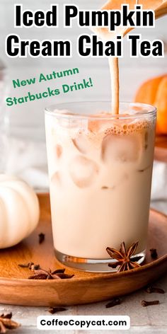 iced pumpkin cream chai tea in a glass on a plate with cinnamons and anise